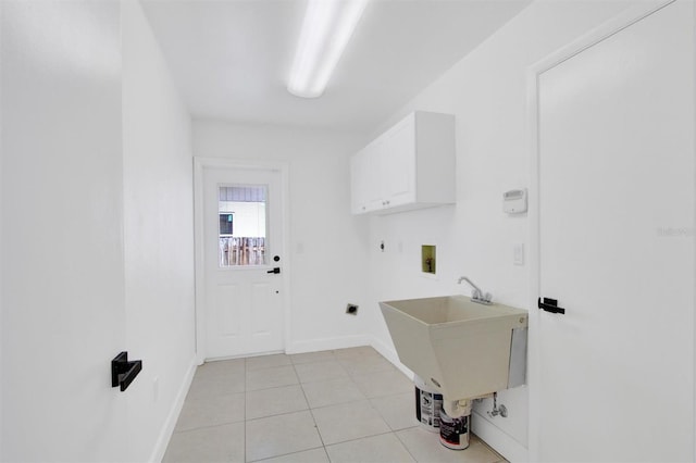 laundry area with light tile patterned floors, hookup for a washing machine, hookup for an electric dryer, baseboards, and cabinet space