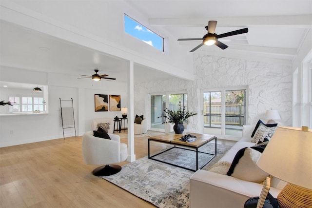 living room featuring ceiling fan, high vaulted ceiling, beam ceiling, and wood finished floors