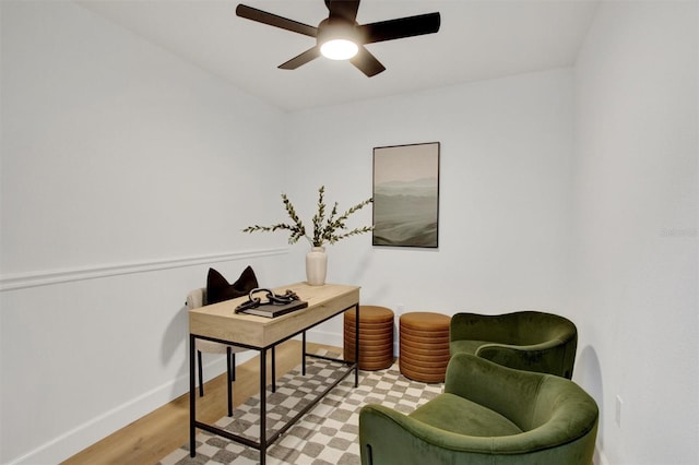 office featuring light wood-type flooring, ceiling fan, and baseboards