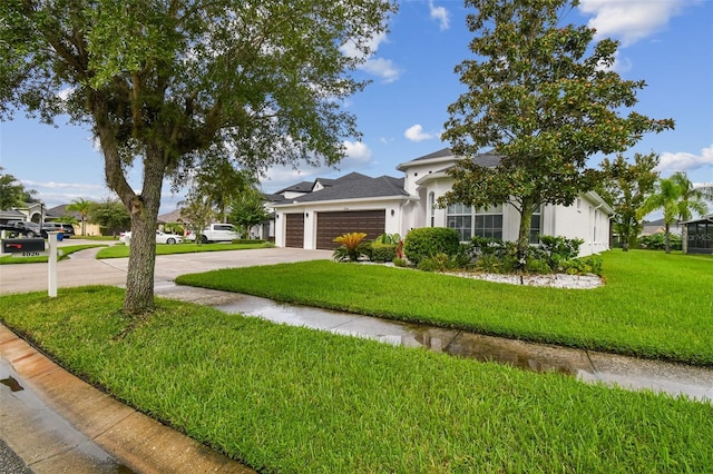 view of front of house featuring concrete driveway, a front lawn, an attached garage, and stucco siding