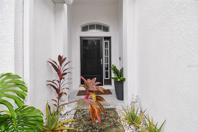 doorway to property with stucco siding