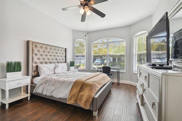 bedroom featuring ceiling fan, baseboards, and dark wood finished floors