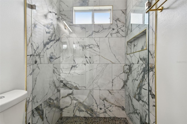 full bathroom with toilet and a marble finish shower