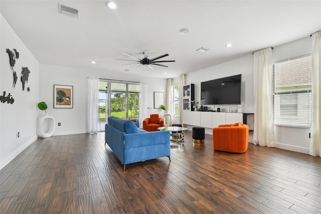 living room featuring baseboards, dark wood finished floors, visible vents, and recessed lighting