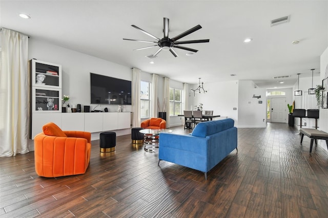 living area featuring recessed lighting, visible vents, and dark wood finished floors