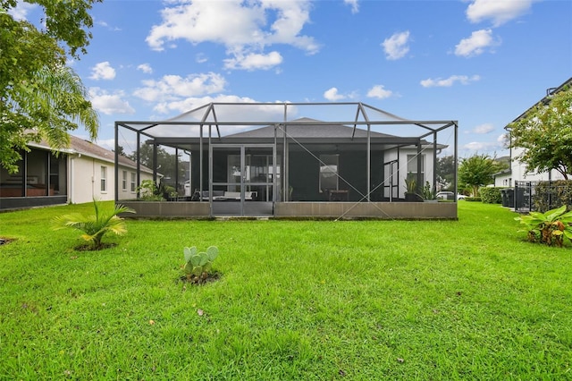 back of property featuring a lawn and a lanai