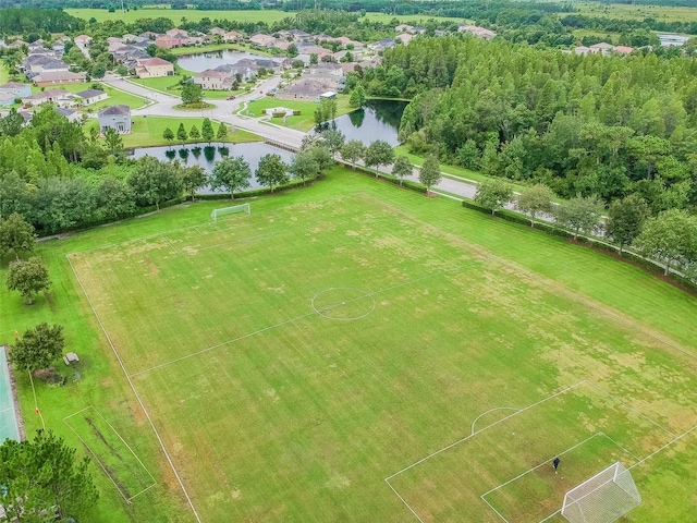 birds eye view of property with a water view and a residential view