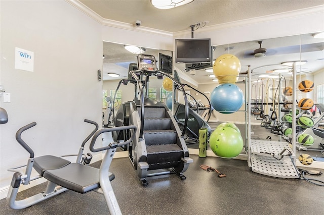 exercise room featuring ornamental molding and a textured ceiling