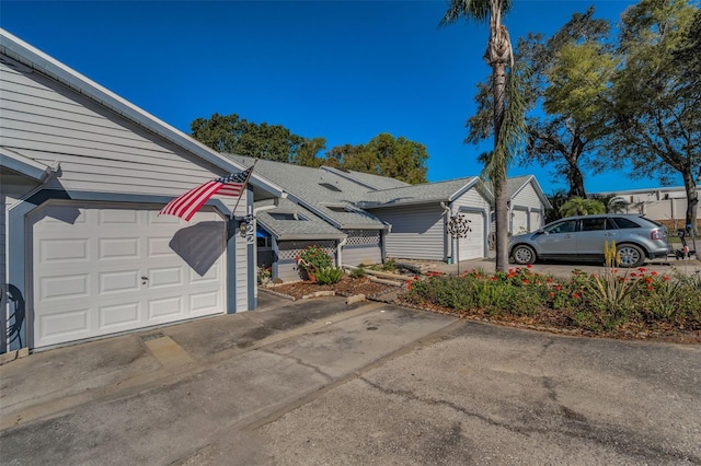 view of side of property featuring driveway and a garage