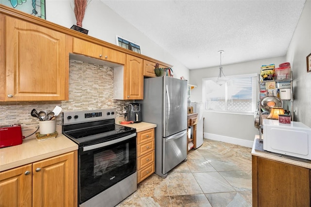 kitchen with light countertops, lofted ceiling, stainless steel appliances, a textured ceiling, and decorative backsplash