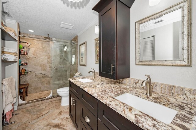 full bath featuring a textured ceiling, a sink, and a stall shower