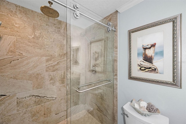 full bath with a shower stall, toilet, and ornamental molding