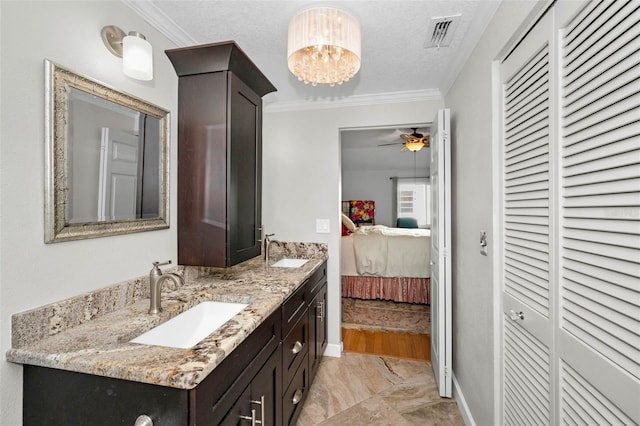 ensuite bathroom with a closet, visible vents, crown molding, connected bathroom, and a sink