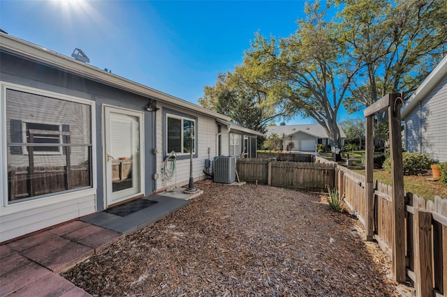 view of yard with central AC unit and fence