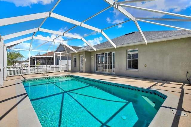 pool with a patio area, a lanai, and fence