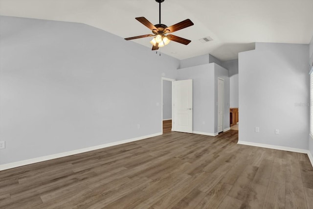 interior space featuring lofted ceiling, a ceiling fan, baseboards, and wood finished floors