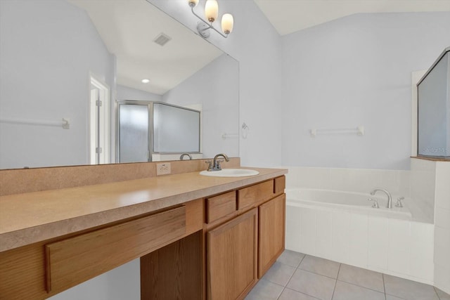 bathroom featuring tile patterned flooring, vaulted ceiling, a bath, and vanity