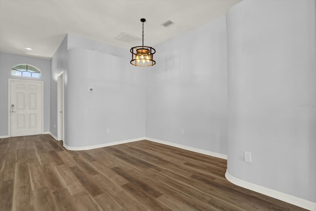 foyer featuring visible vents, baseboards, and wood finished floors