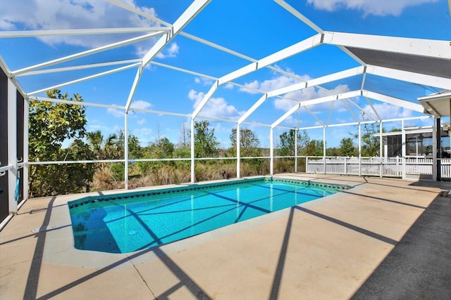 outdoor pool featuring a lanai and a patio