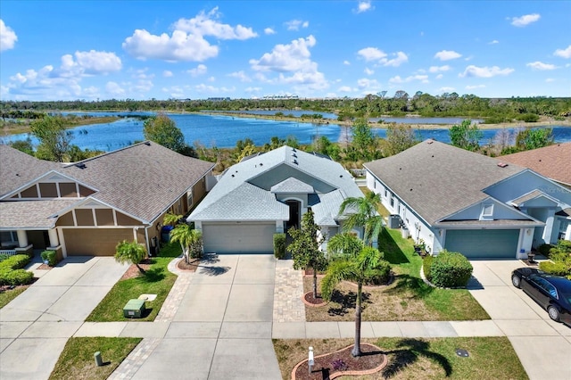 birds eye view of property featuring a water view and a residential view