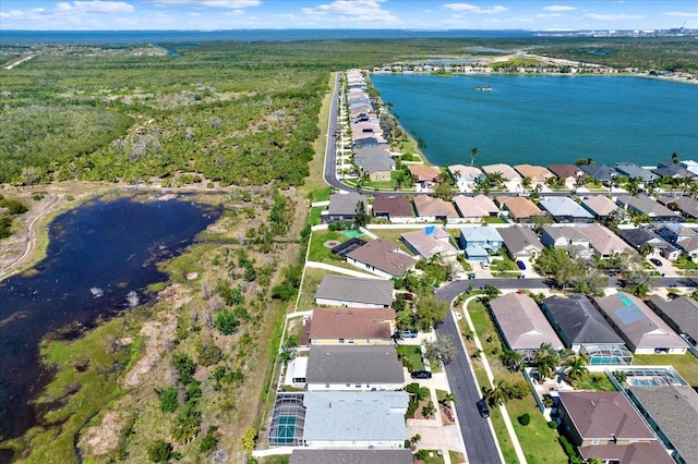 bird's eye view featuring a water view and a residential view