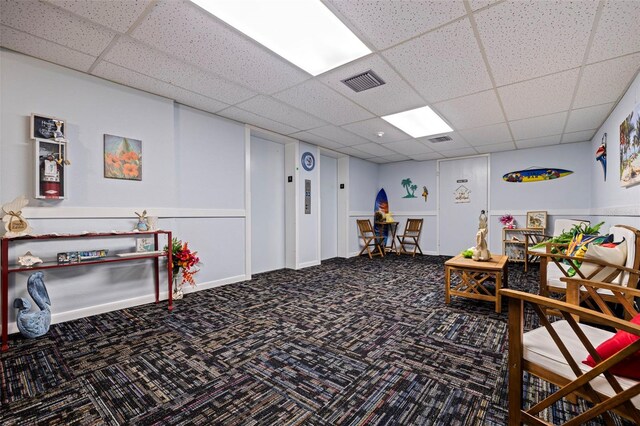 game room featuring carpet, visible vents, and a drop ceiling