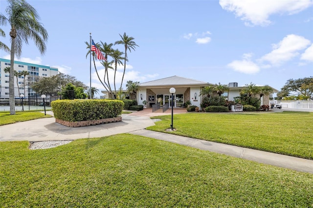 view of property's community with fence and a yard