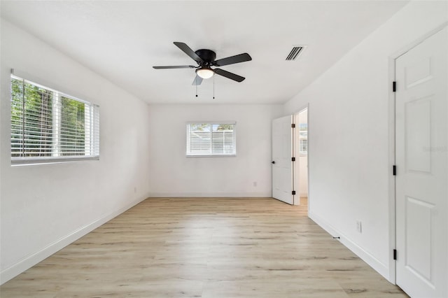 unfurnished bedroom with ceiling fan, light wood-style flooring, visible vents, and baseboards