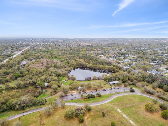 aerial view featuring a water view and a wooded view
