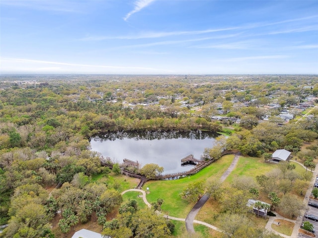 aerial view with a water view and a forest view