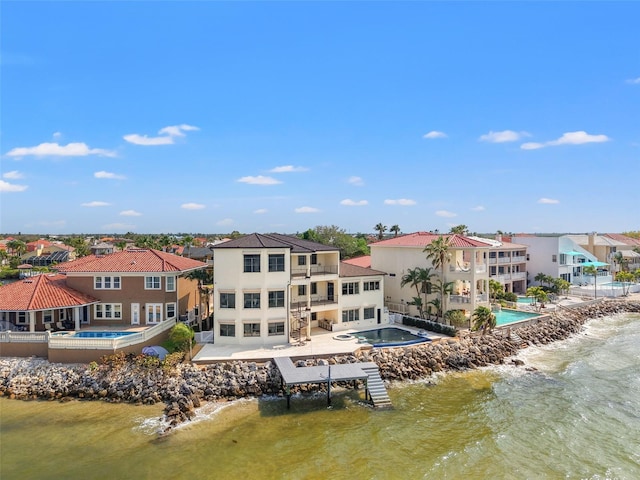 drone / aerial view with a residential view and a water view