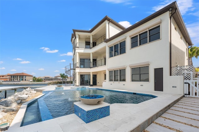 outdoor pool featuring an in ground hot tub and a patio area