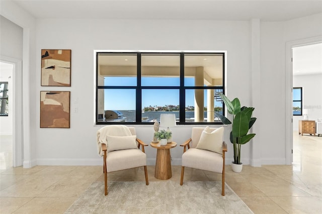 living area featuring tile patterned floors and baseboards