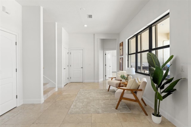 hall with recessed lighting, visible vents, and baseboards