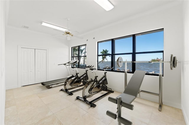 workout room with light tile patterned floors, visible vents, baseboards, and a ceiling fan