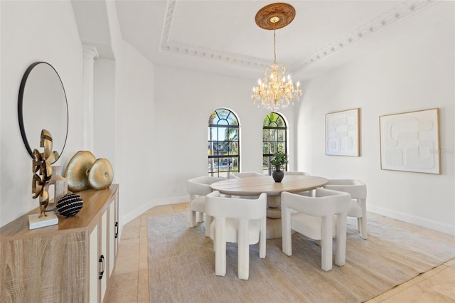 dining area featuring a tray ceiling, a notable chandelier, light tile patterned flooring, and baseboards