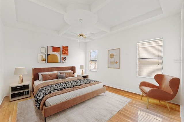 bedroom featuring light wood-type flooring, baseboards, coffered ceiling, and beamed ceiling