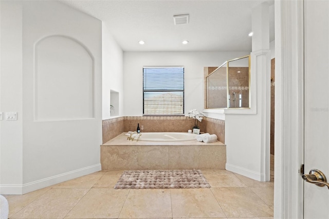 full bath with baseboards, visible vents, a tile shower, tile patterned flooring, and a garden tub