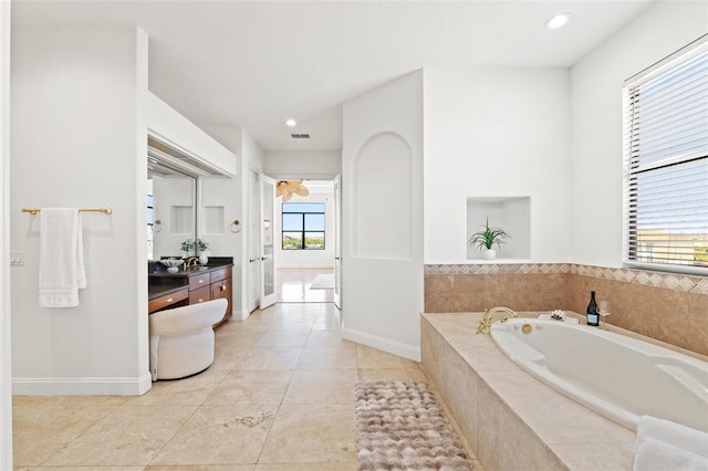 full bath with tile patterned flooring, baseboards, a garden tub, recessed lighting, and vanity