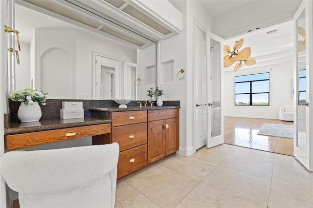 bathroom with tile patterned floors, visible vents, french doors, baseboards, and vanity