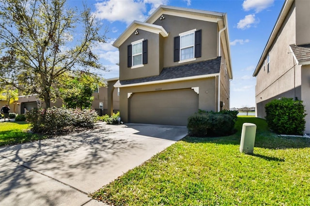 traditional home with concrete driveway, stucco siding, roof with shingles, an attached garage, and a front yard