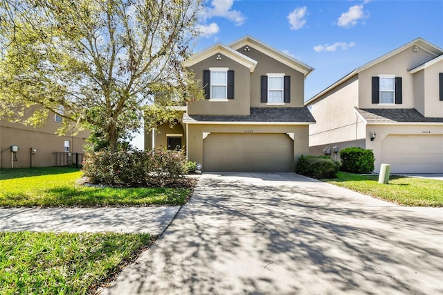 view of front of house featuring stucco siding, a shingled roof, an attached garage, driveway, and a front lawn