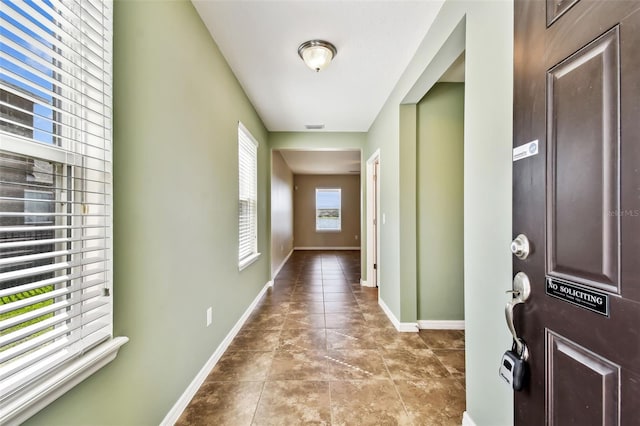 entryway with tile patterned floors, visible vents, and baseboards