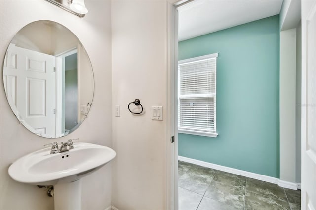 bathroom with baseboards and a sink