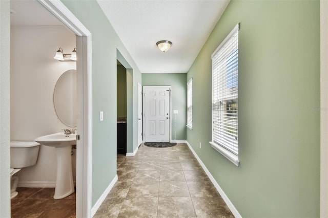 interior space featuring tile patterned flooring and baseboards