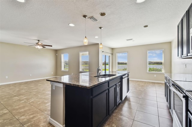 kitchen featuring a wealth of natural light, appliances with stainless steel finishes, visible vents, and a sink