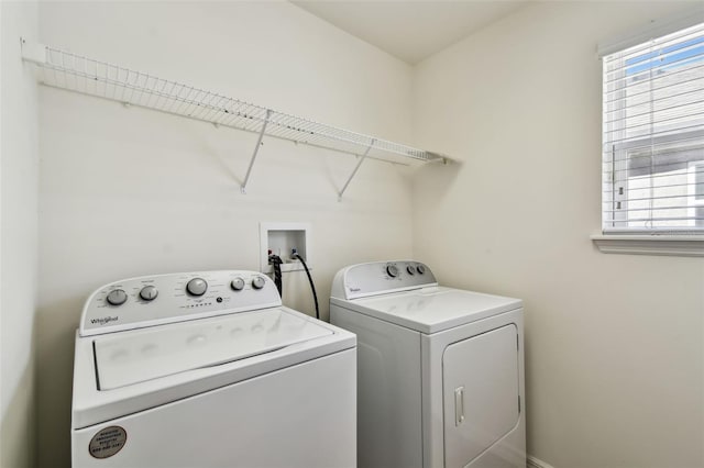 clothes washing area with plenty of natural light, laundry area, and independent washer and dryer