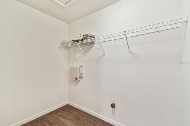 laundry area featuring laundry area, baseboards, dark colored carpet, and hookup for an electric dryer