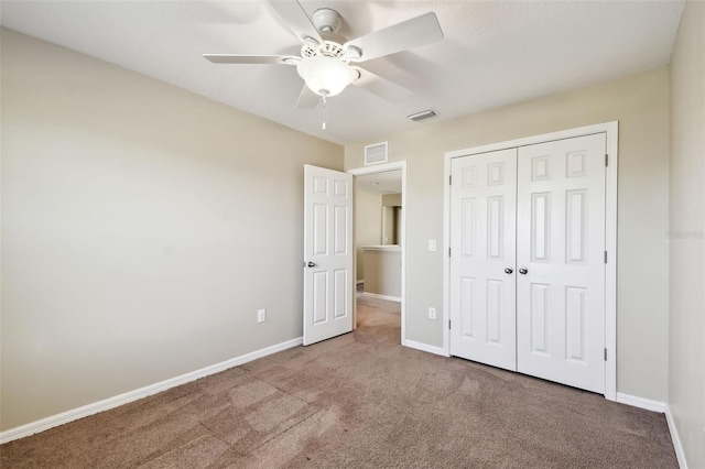 unfurnished bedroom featuring carpet, baseboards, and visible vents