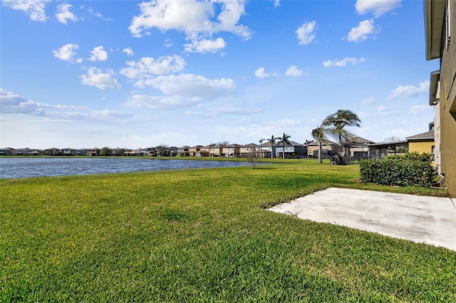 view of yard featuring a residential view and a water view